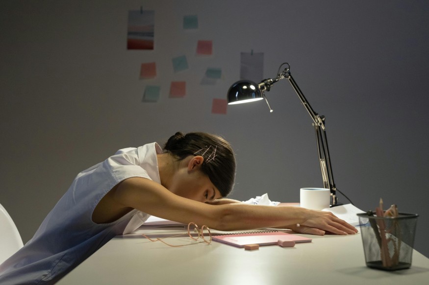 girl sleeping on desk