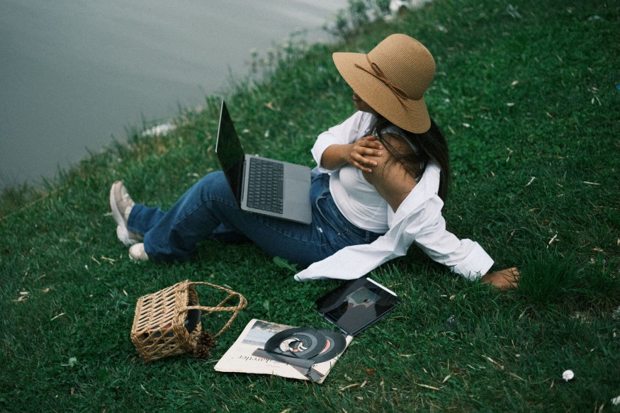 girl in grass wth gadgets