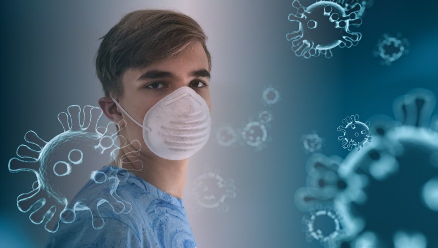 Young man wearing respiratory mask