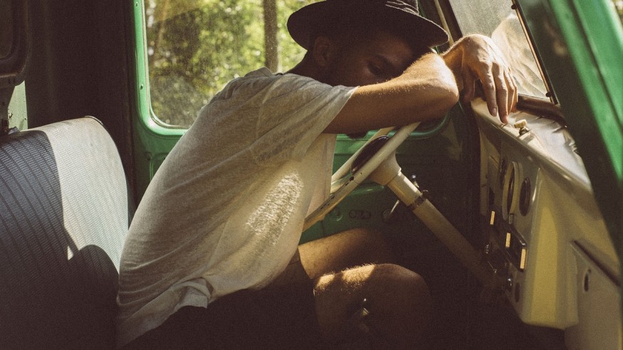 tired man sleeps in van
